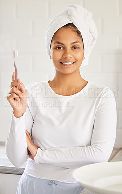 Buy stock photo Shot of a beautiful young woman brushing her teeth in the morning