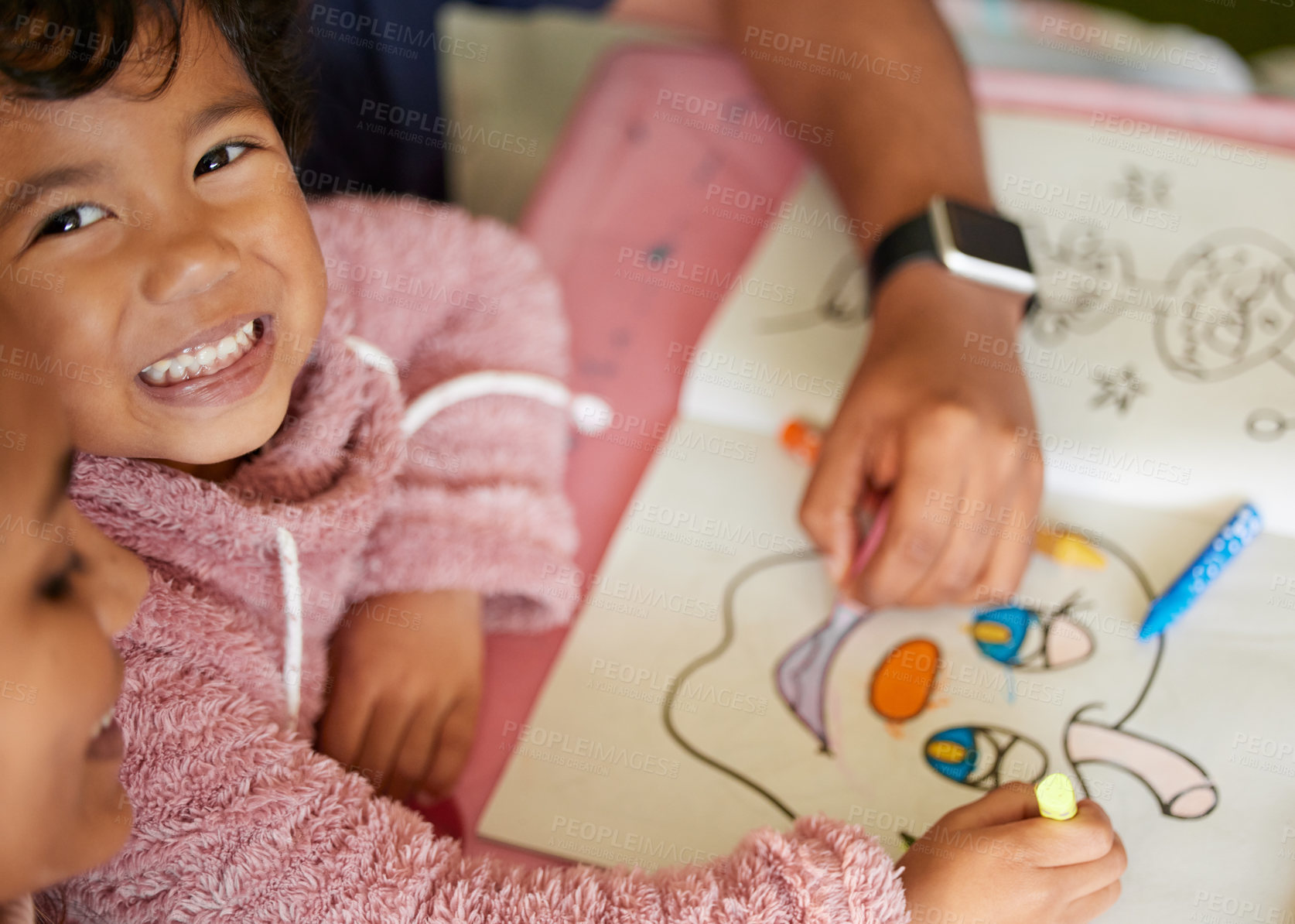 Buy stock photo Shot of a little girl and her mother colouring in a book