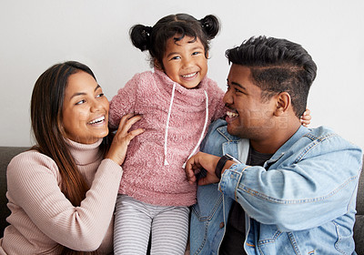 Buy stock photo Shot of parent playfully tickling their daughter