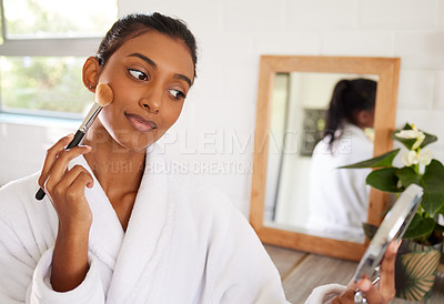 Buy stock photo Shot of a beautiful young woman going through her makeup routine at home