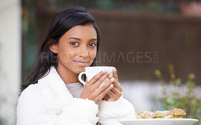 Buy stock photo Shot of a young woman drinking a cup of coffee