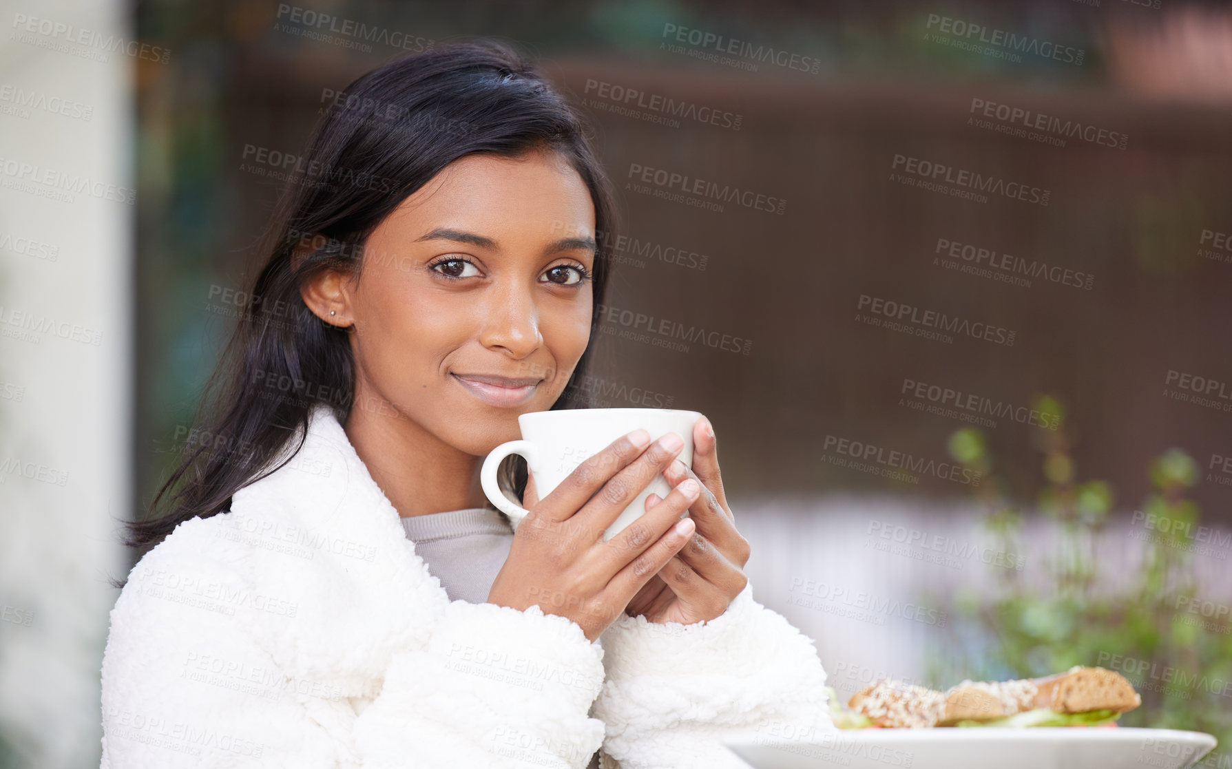 Buy stock photo Shot of a young woman drinking a cup of coffee