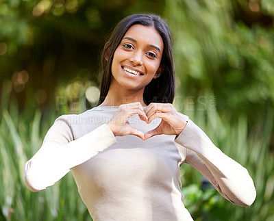 Buy stock photo Portrait, smile and woman with heart hands in nature for love, care and affection. Face, love hand gesture and Indian female person with emoji for kindness, empathy or romance, support and trust.
