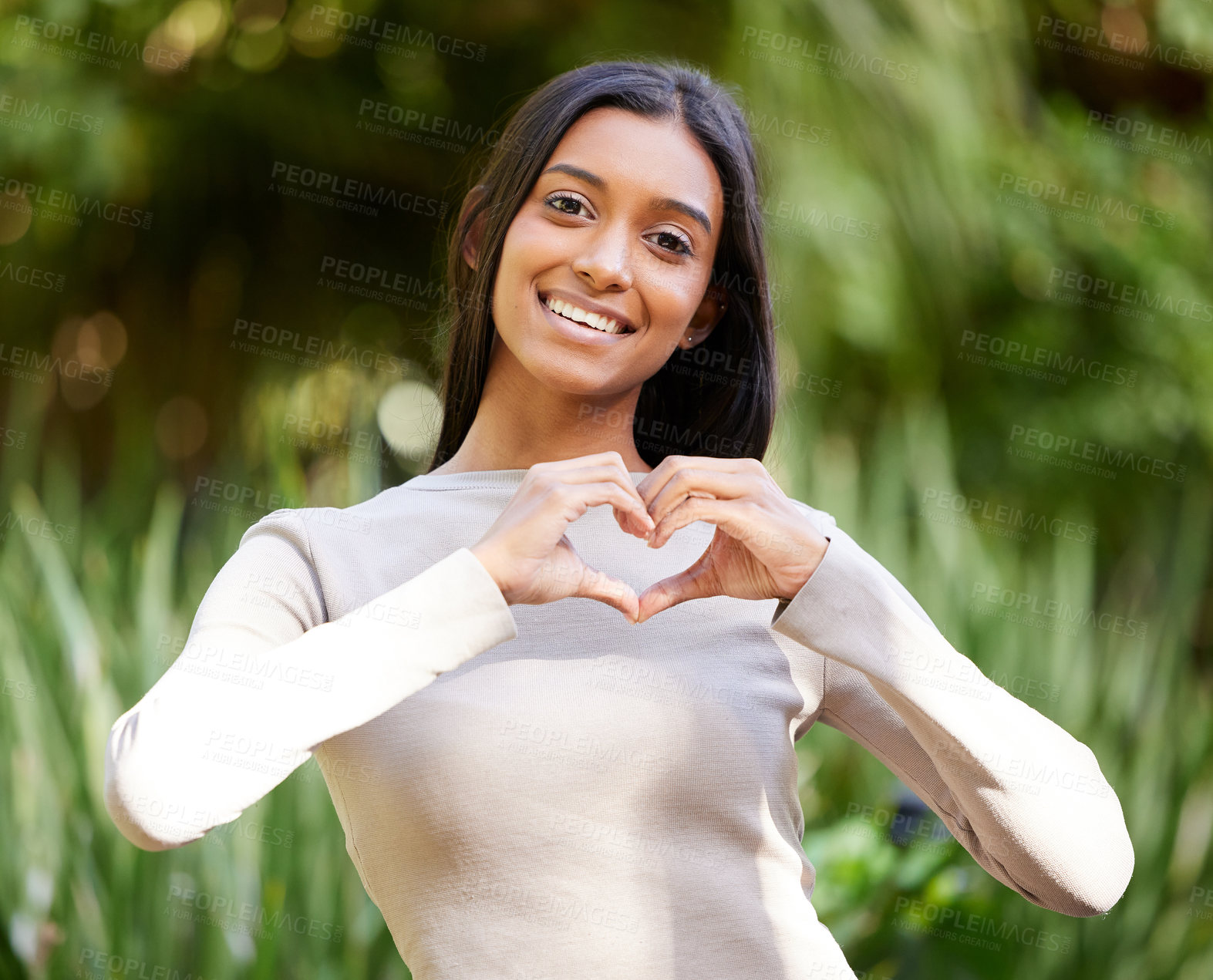 Buy stock photo Portrait, smile and woman with heart hands in nature for love, care and affection. Face, love hand gesture and Indian female person with emoji for kindness, empathy or romance, support and trust.