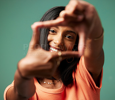 Buy stock photo Shot of a young woman making a shape with her hands shot against a studio background