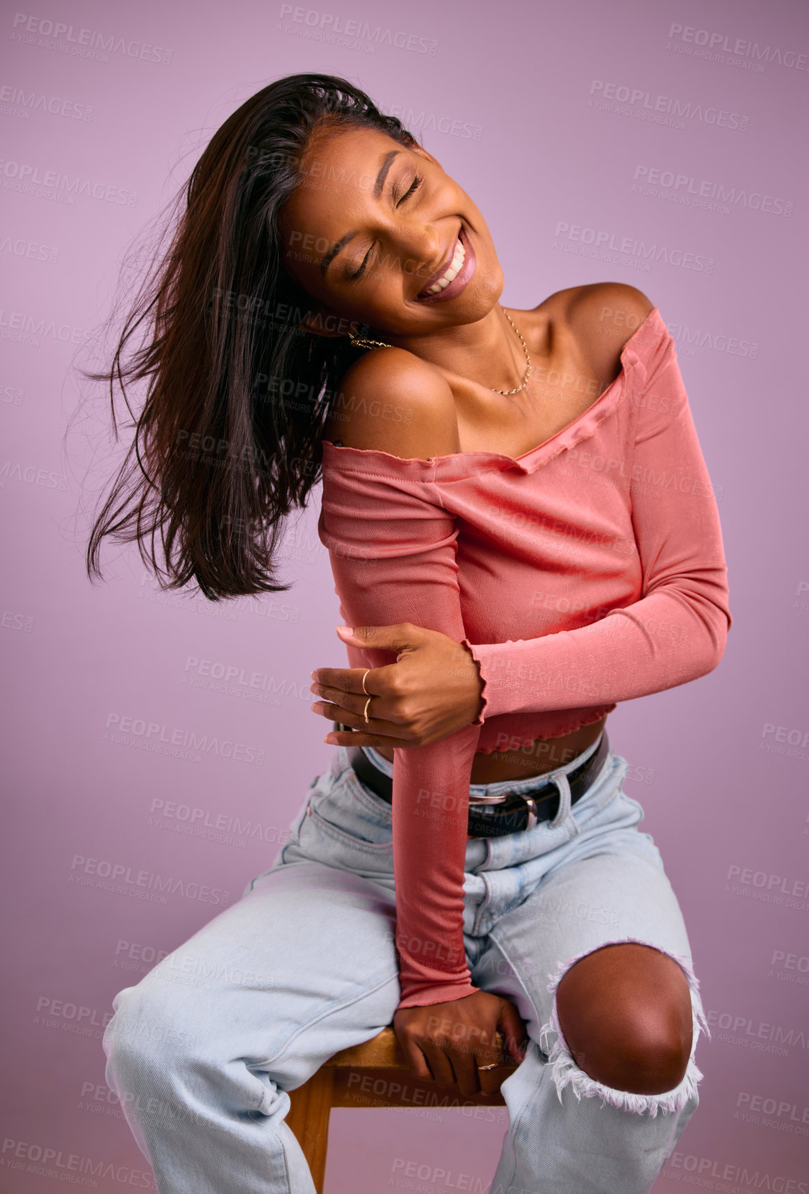 Buy stock photo Indian woman, fashion and chair in studio, confident and jewelry or smile on purple background. Woman, aesthetic and designer outfit or casual style, play and proud female person in cool clothes