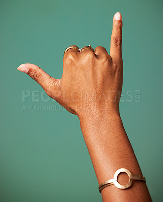 Buy stock photo Woman, Shaka sign and hand in studio for surfer greeting, sign language and freedom. Emoji, icon and symbol of a female person with jewelry and hands for respect and hang loose on a green background