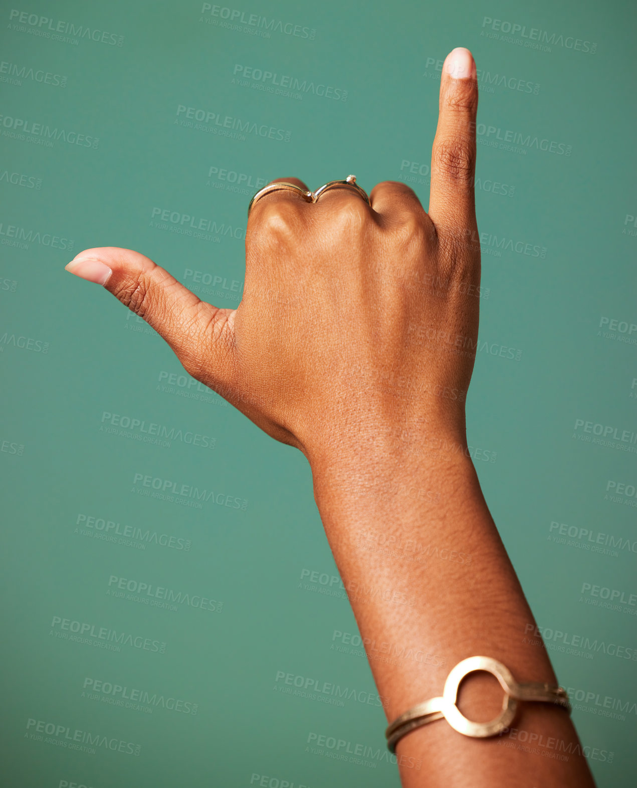 Buy stock photo Woman, Shaka sign and hand in studio for surfer greeting, sign language and freedom. Emoji, icon and symbol of a female person with jewelry and hands for respect and hang loose on a green background