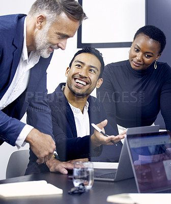 Buy stock photo Shot of a group of businesspeople using a laptop at work