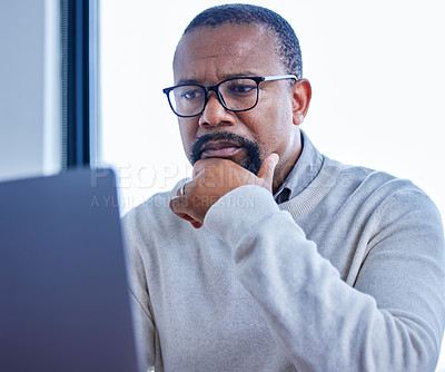 Buy stock photo Thinking, business and mature black man on laptop working on project or research on internet in office. Technology, idea and African manager reading news or company report for financial info or email