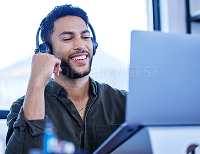 Buy stock photo Shot of a young call centre agent working on a laptop in an office