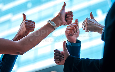 Buy stock photo Shot of a group of young businesspeople giving each other a thumbs up against an urban background