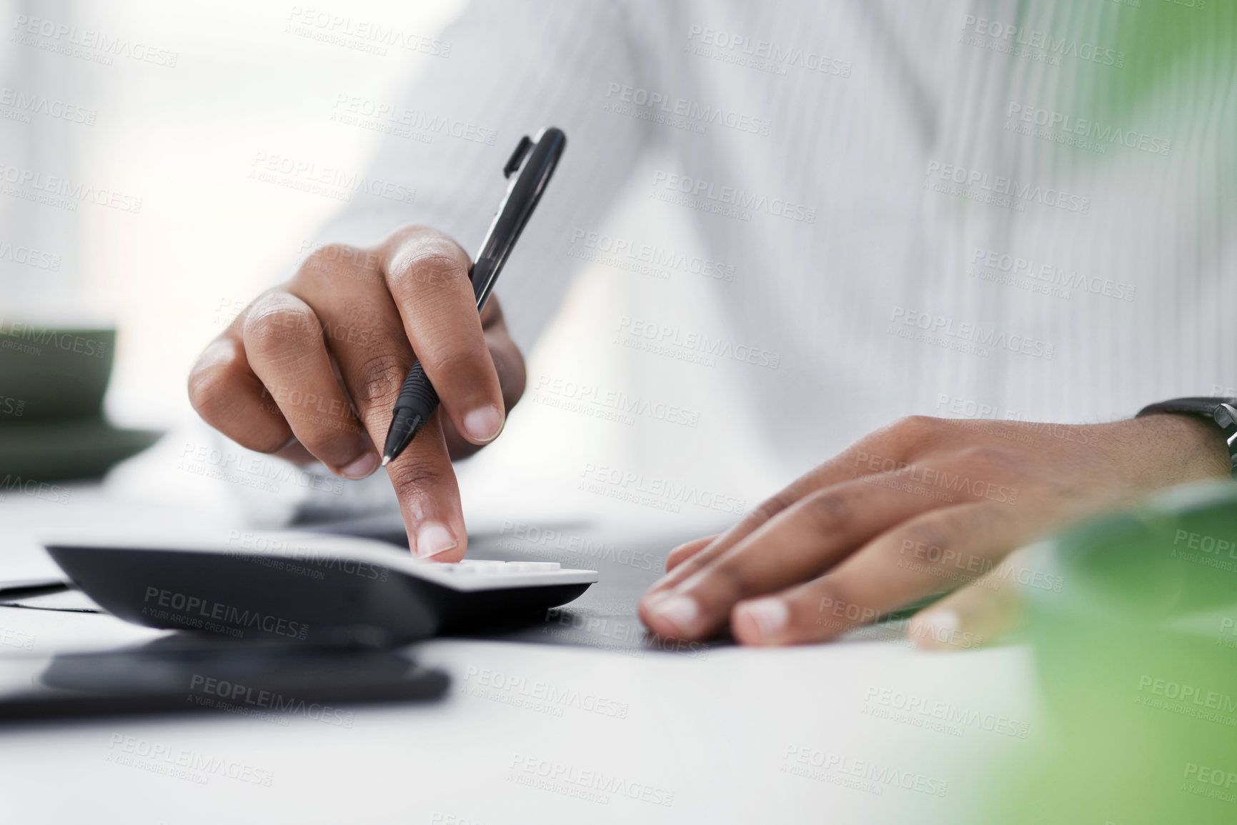 Buy stock photo Closeup shot of an unrecognisable businessman using a calculator in an office