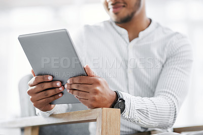 Buy stock photo Closeup shot of an unrecognisable businessman using a digital tablet in an office