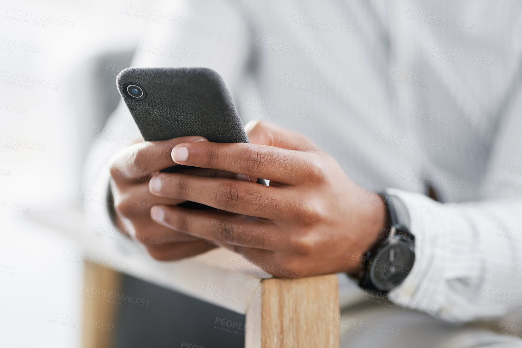 Buy stock photo Closeup shot of an unrecognisable businessman using a cellphone in an office