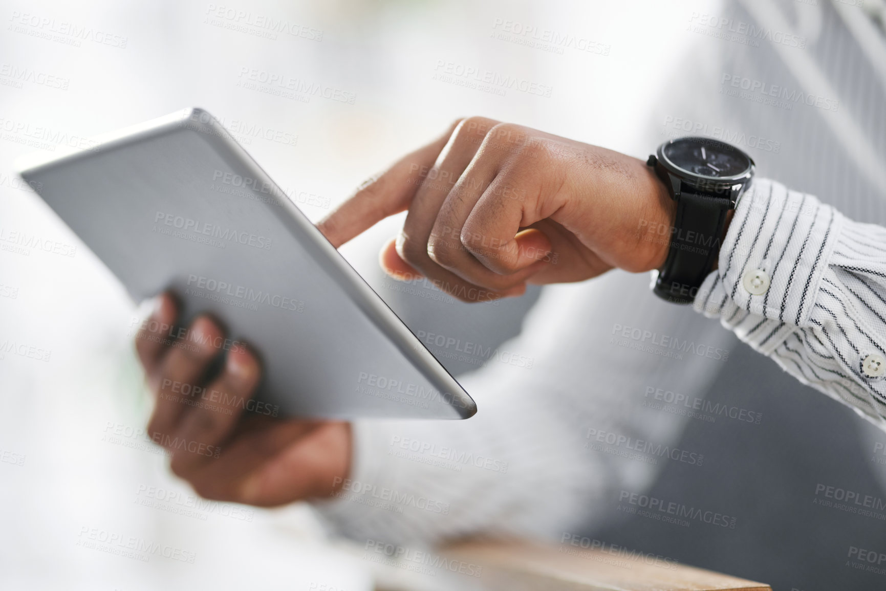 Buy stock photo Closeup shot of an unrecognisable businessman using a digital tablet in an office