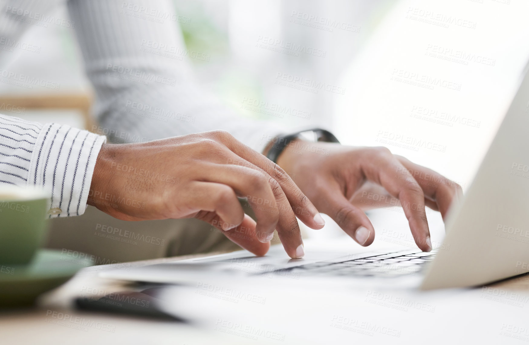 Buy stock photo Closeup shot of an unrecognisable businessman using a laptop in an office