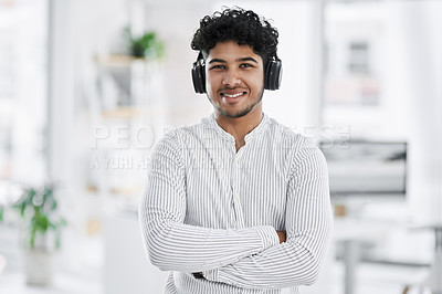 Buy stock photo Portrait of a young businessman wearing headphones in an office