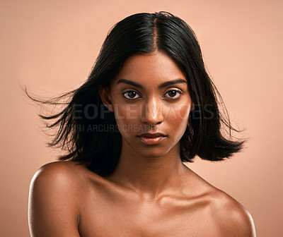 Buy stock photo Portrait of a beautiful young woman posing against a brown background