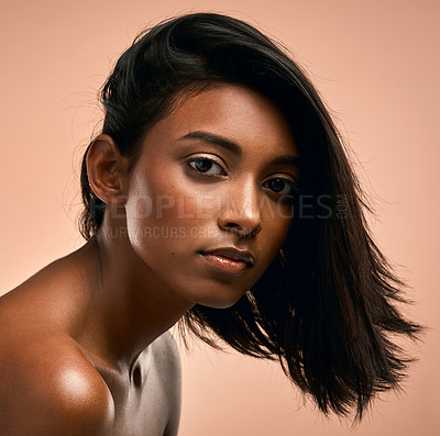 Buy stock photo Portrait of a beautiful young woman posing against a brown background