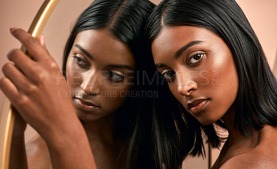 Buy stock photo Portrait of a beautiful young woman holding a mirror and  posing against a brown background