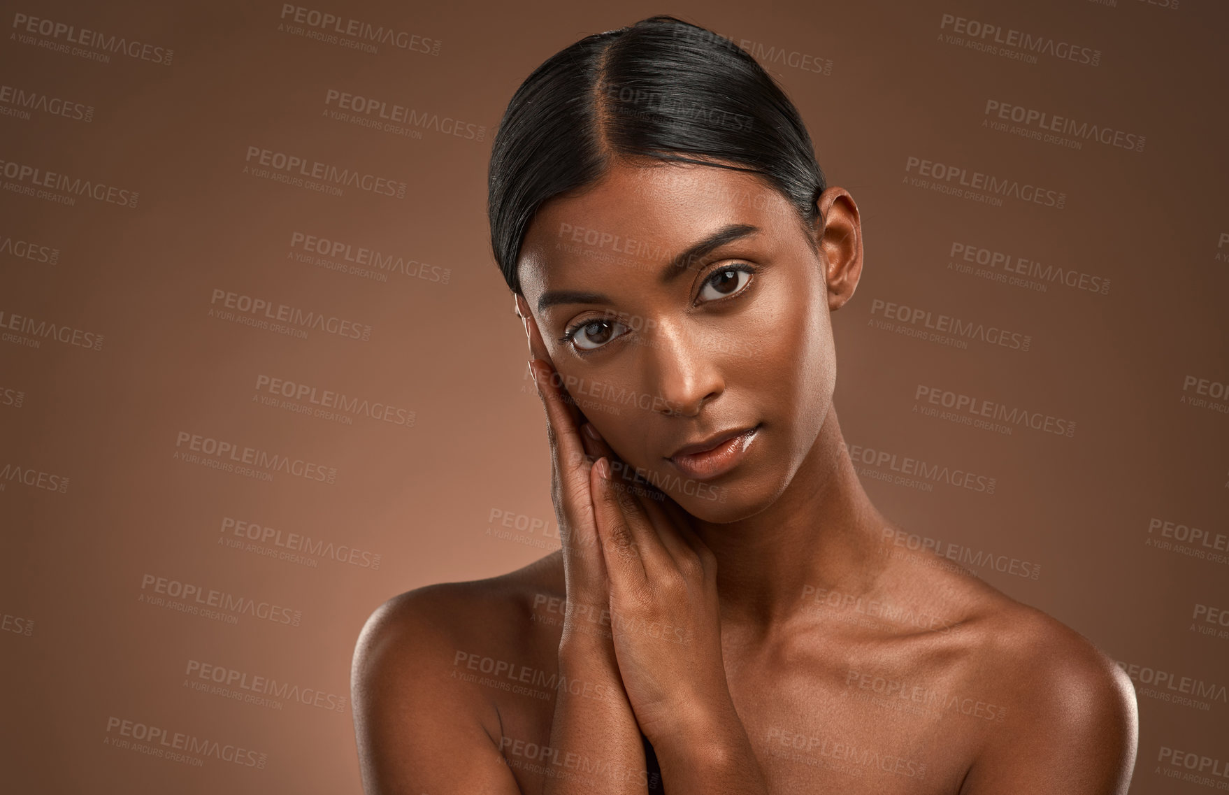 Buy stock photo Portrait of a beautiful young woman posing against a brown background