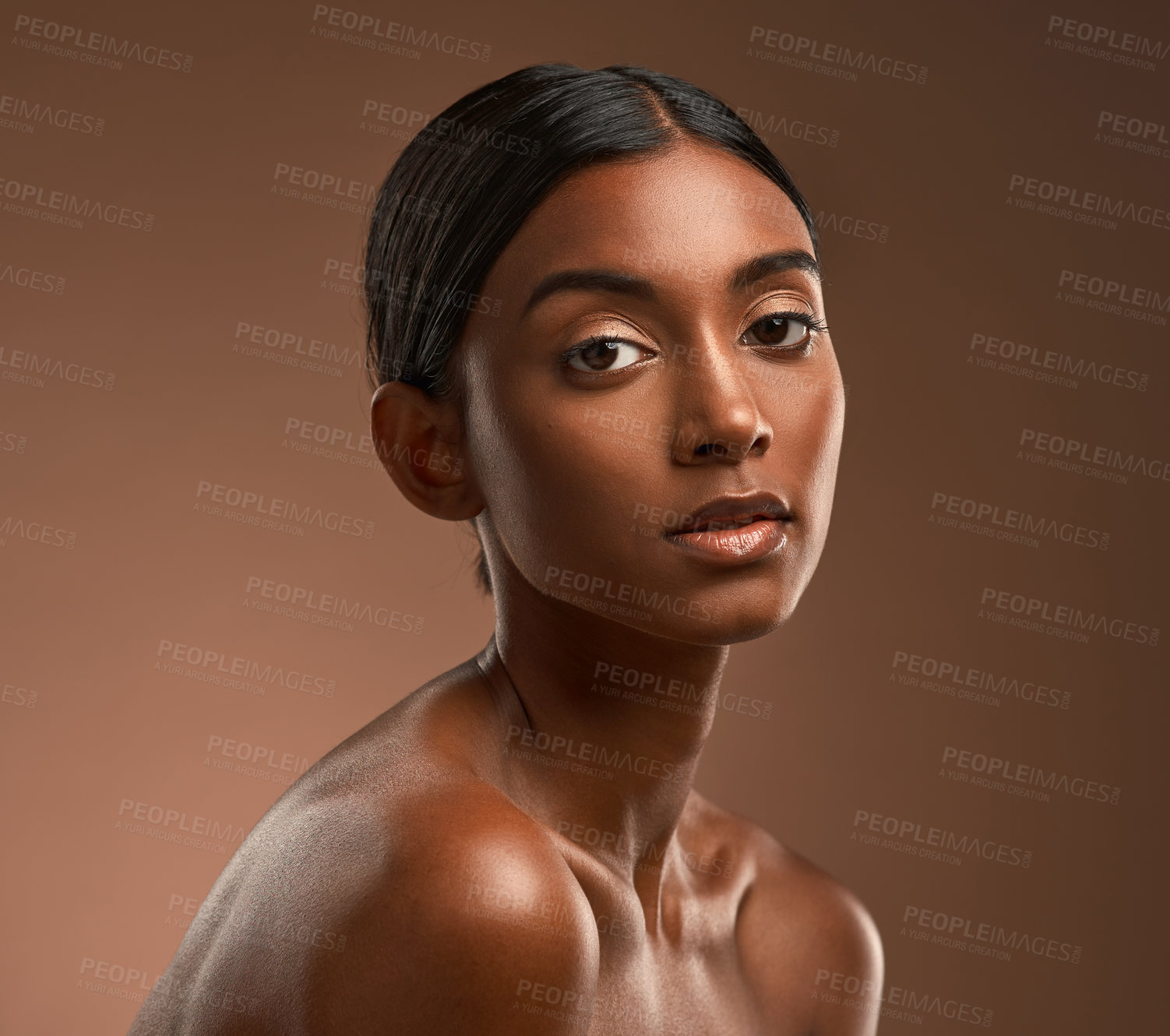 Buy stock photo Portrait of a beautiful young woman posing against a brown background