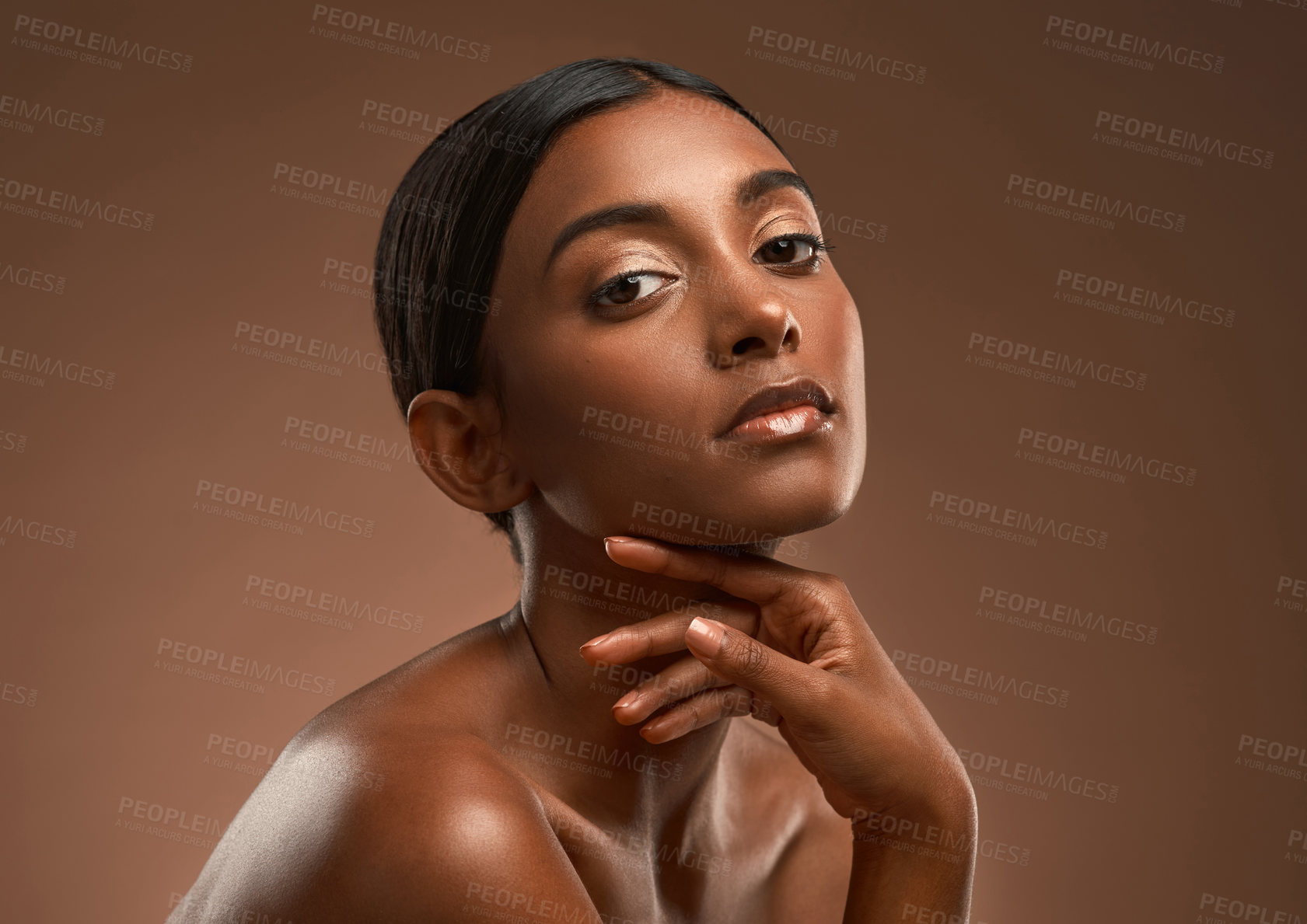 Buy stock photo Portrait of a beautiful young woman posing against a brown background