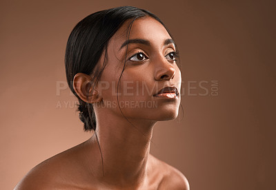 Buy stock photo Shot of a beautiful young woman posing against a brown background