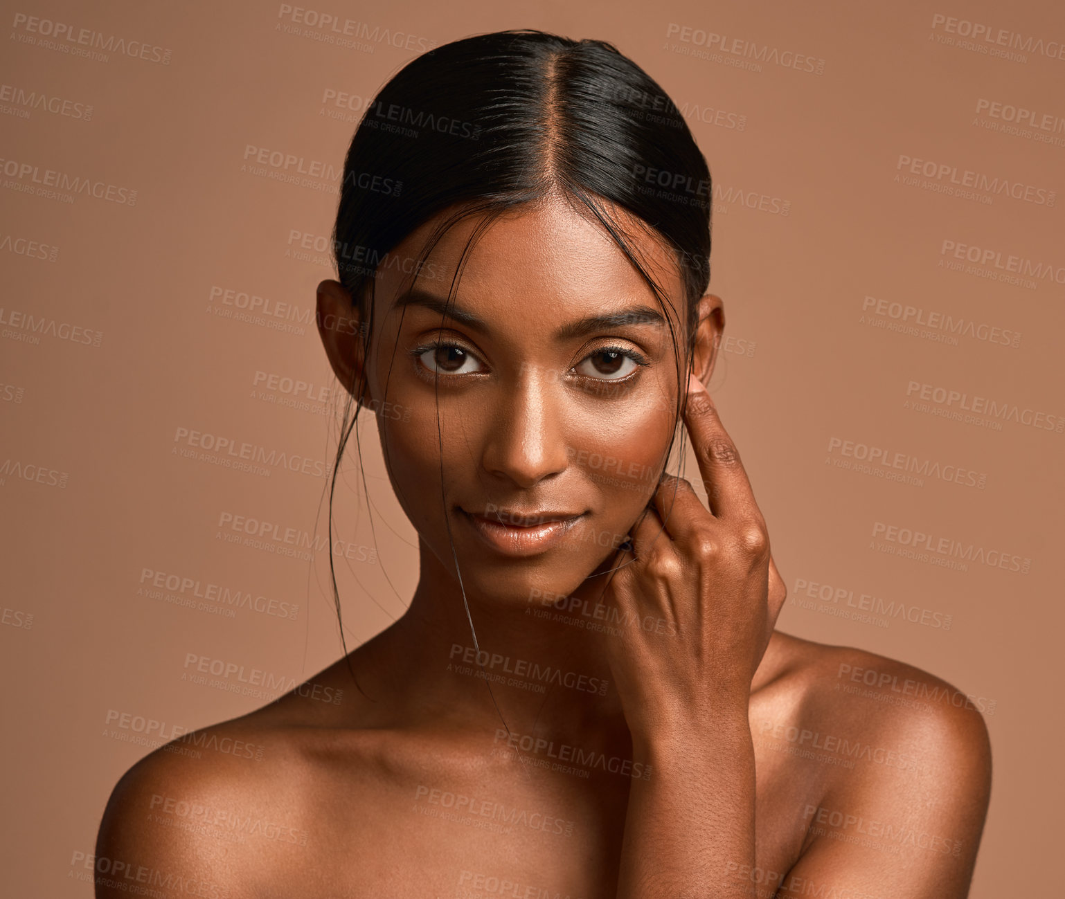 Buy stock photo Portrait of a beautiful young woman posing against a brown background