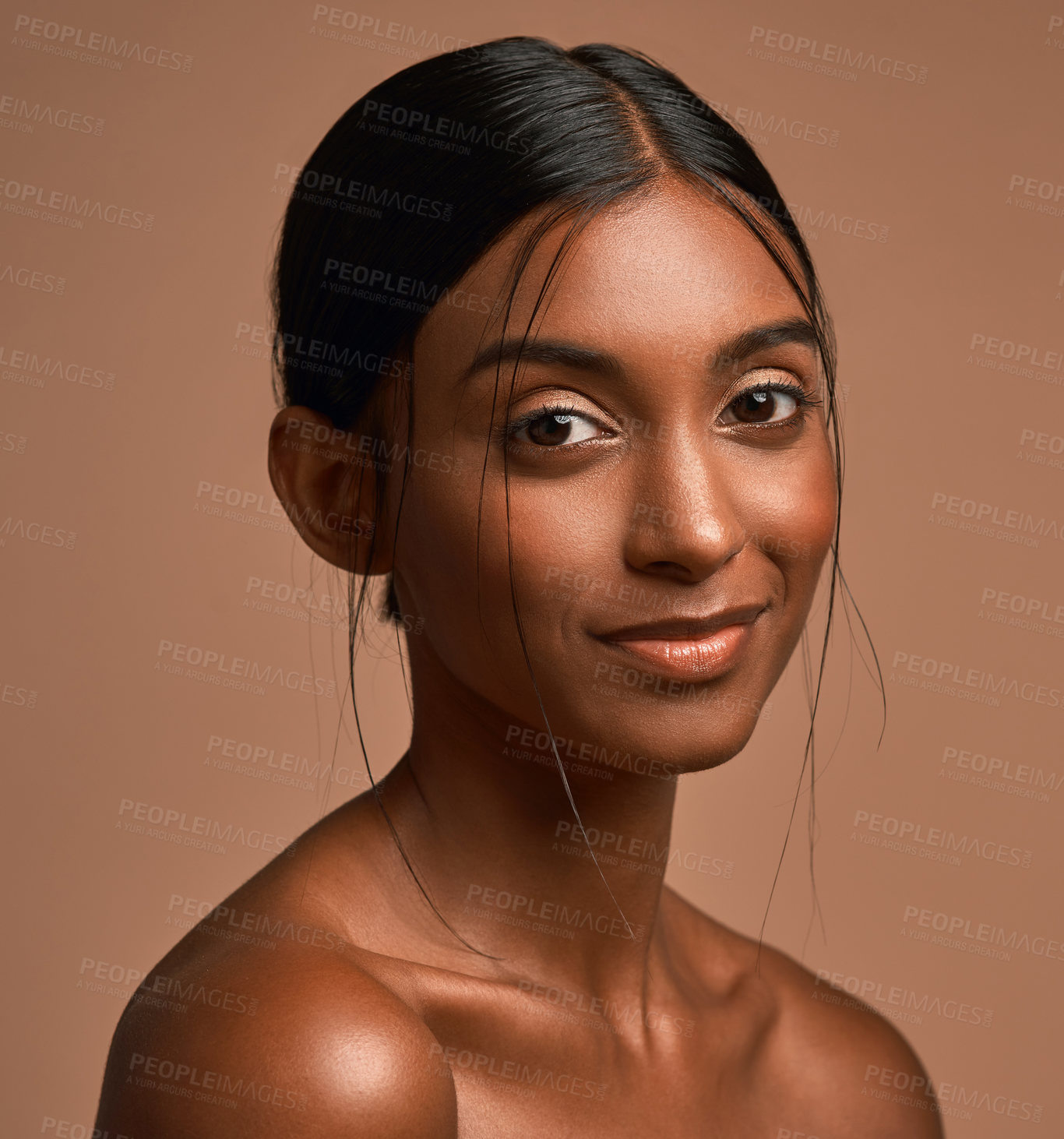 Buy stock photo Portrait of a beautiful young woman posing against a brown background