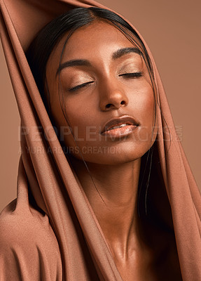 Buy stock photo Shot of an attractive young woman wearing a head scarf against a brown background