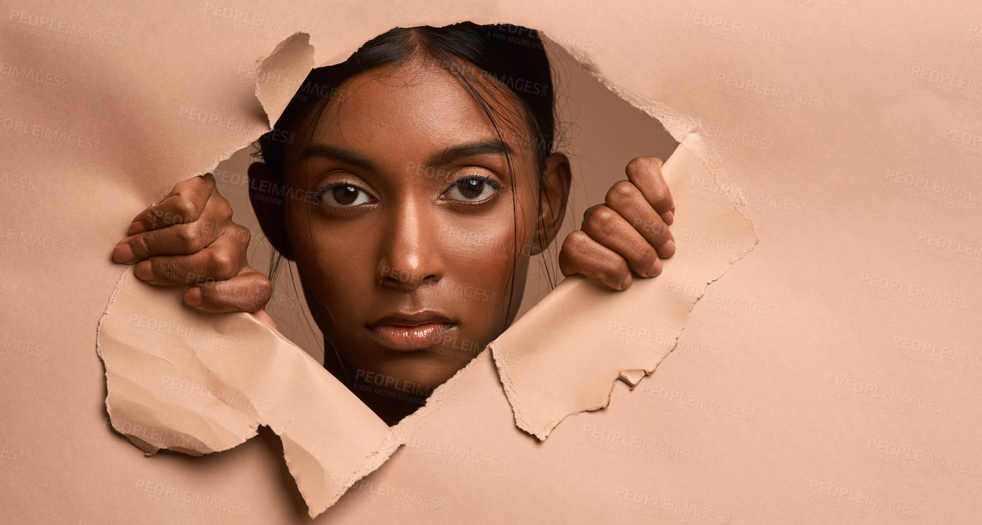 Buy stock photo Closeup portrait of a young attractive woman tearing through brown paper