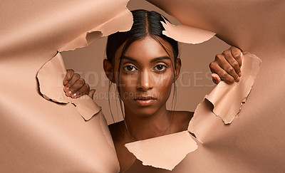 Buy stock photo Closeup portrait of a young attractive woman tearing through brown paper