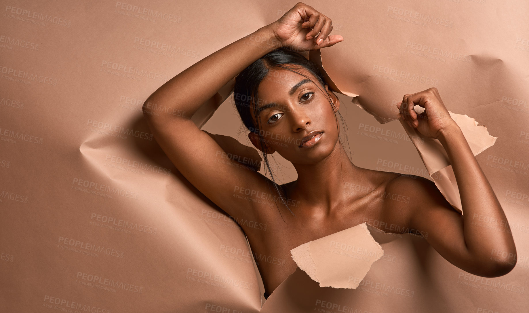 Buy stock photo Portrait of a young attractive woman tearing through brown paper