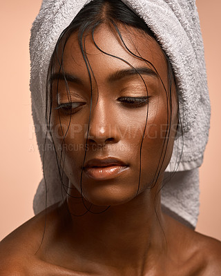 Buy stock photo Closeup shot of a beautiful young woman with her hair wrapped in a towel against a brown background