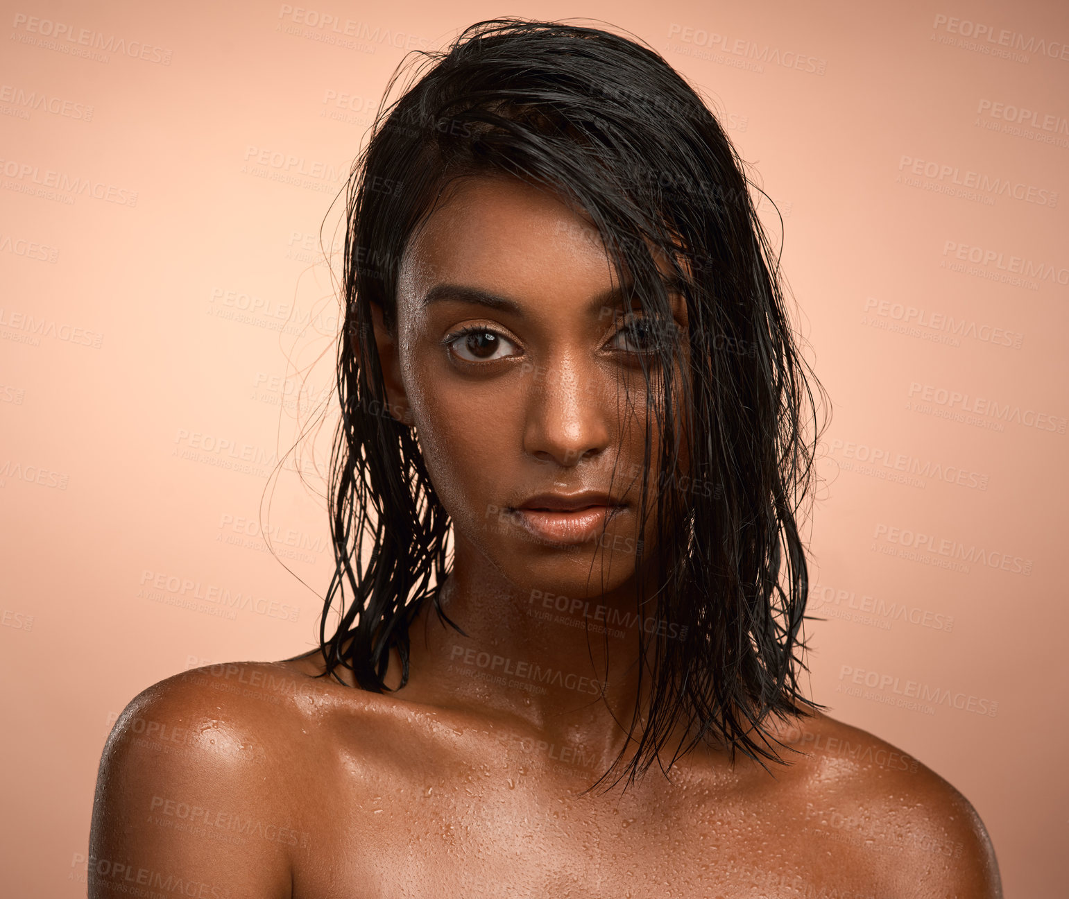 Buy stock photo Portrait of a beautiful young woman after having a refreshing shower against a brown background