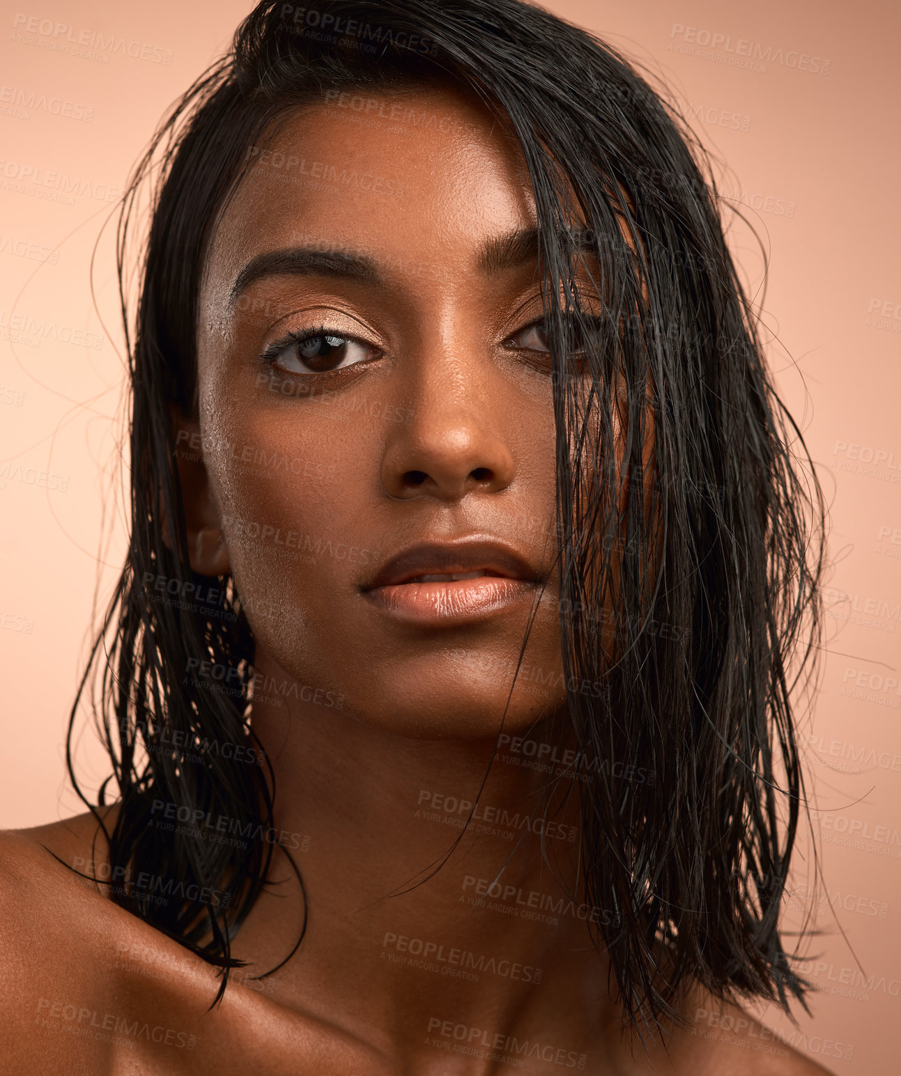 Buy stock photo Portrait of a beautiful young woman after having a refreshing shower against a brown background