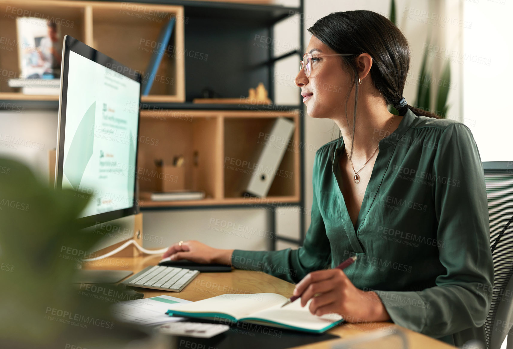 Buy stock photo Shot of a young businesswoman looking at her computer screen at work