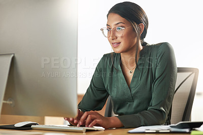 Buy stock photo Shot of a young businesswoman typing on her desktop PC keyboard