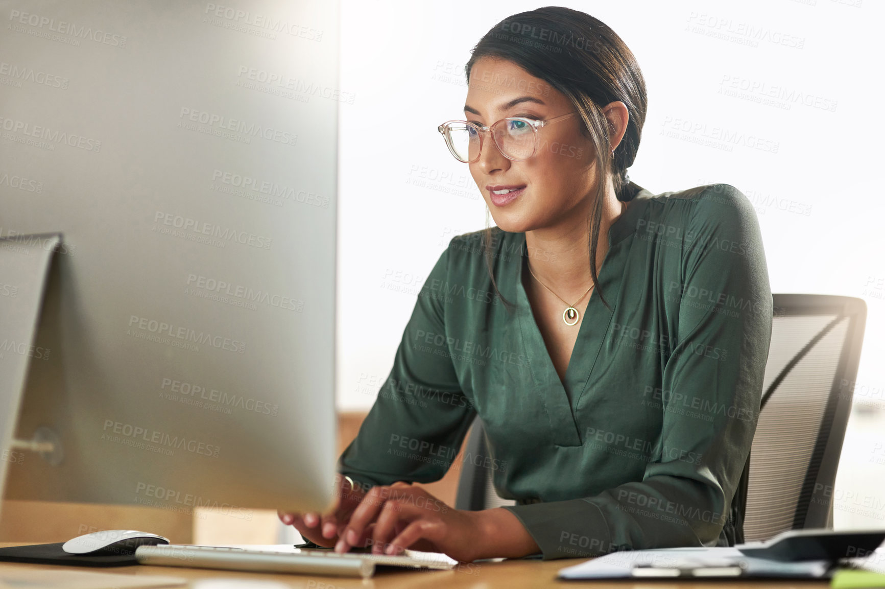 Buy stock photo Shot of a young businesswoman typing on her desktop PC keyboard