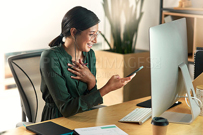 Buy stock photo Shot of a young businesswoman using her smartphone to send text messages