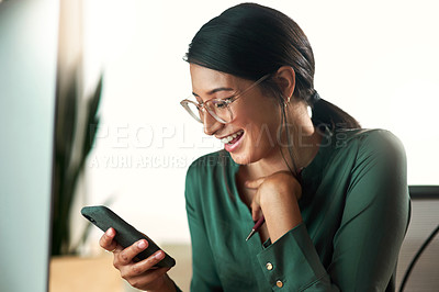 Buy stock photo Shot of a young businesswoman using her smartphone to send text messages