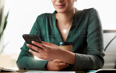 Buy stock photo Shot of a businesswoman using her smartphone at her desk