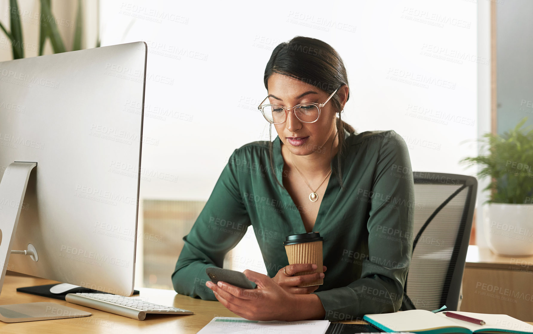 Buy stock photo Shot of a young businesswoman using her smartphone to send text messages