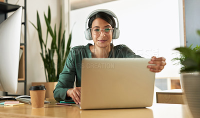 Buy stock photo Shot of a young businesswoman using her laptop to host a video conference at work