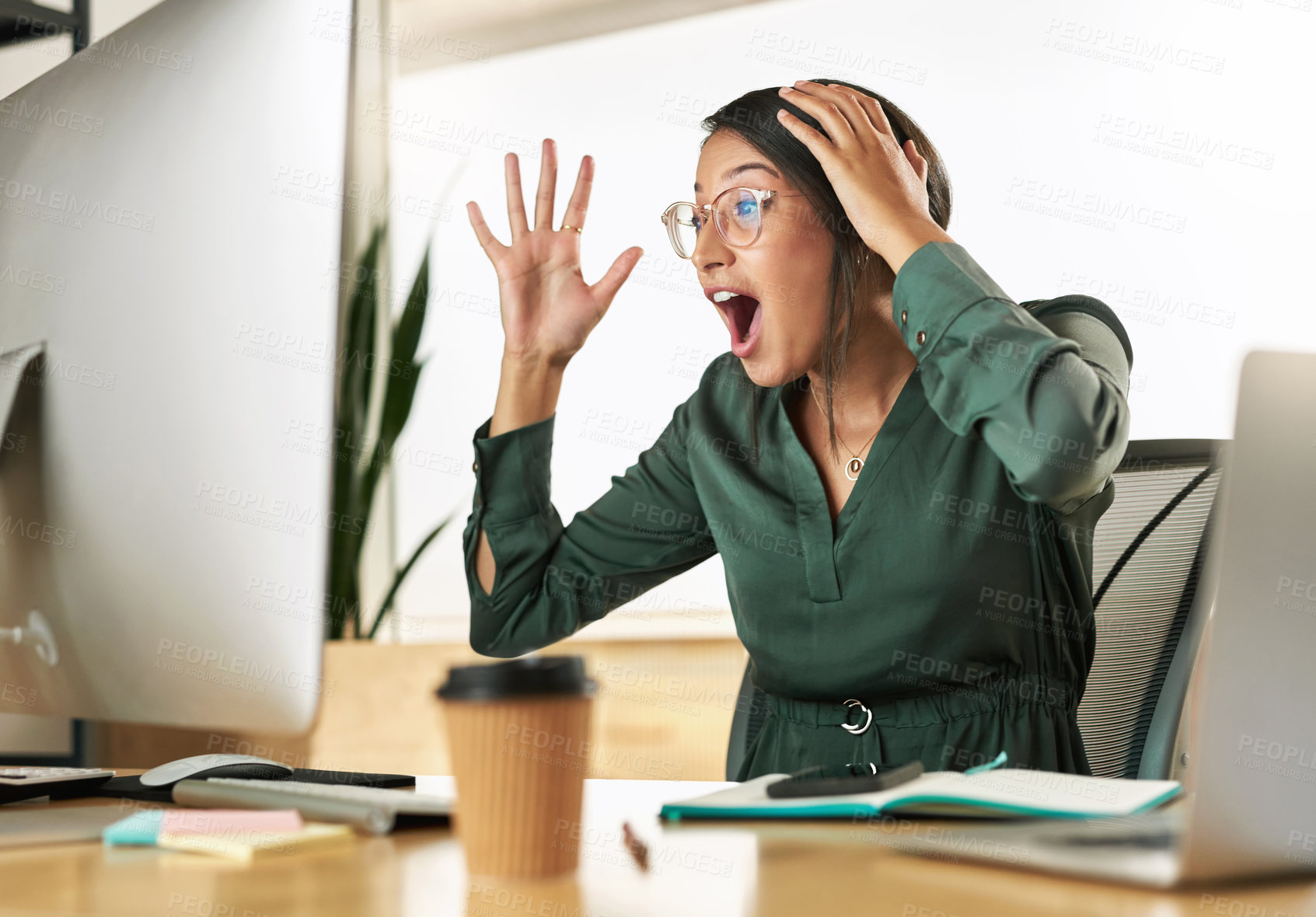 Buy stock photo Shot of a young businesswoman looking at her PC screen in shock