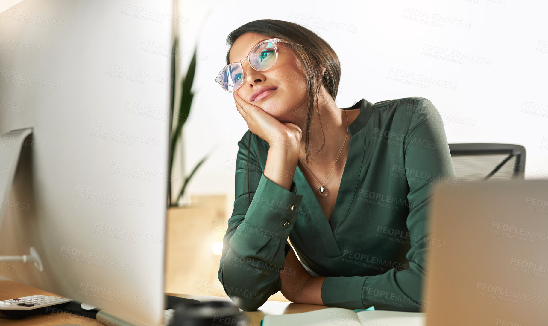 Buy stock photo Shot of a young businesswoman staring at her PC screen in boredom