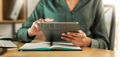 Buy stock photo Shot of a businesswoman using her digital tablet at her desk