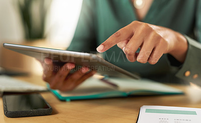 Buy stock photo Shot of a businesswoman using her digital tablet at her desk